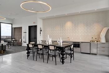 A modern dining room with a large table and chairs.